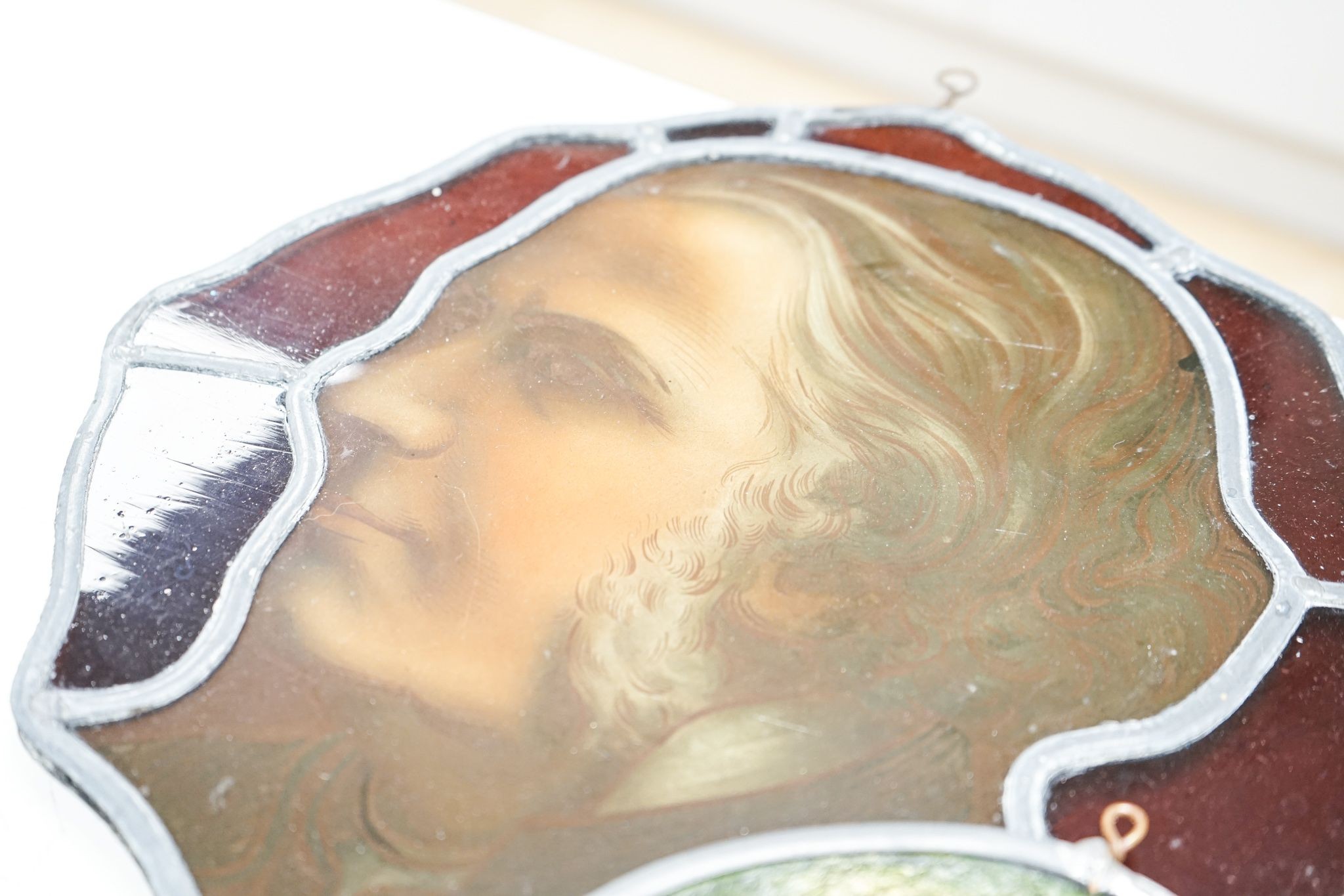 A Victorian stained glass portrait panel, two bird panels and a similar circular bird panel (4)